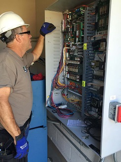 IEI technician performing maintenance at a public pool and water slide facility